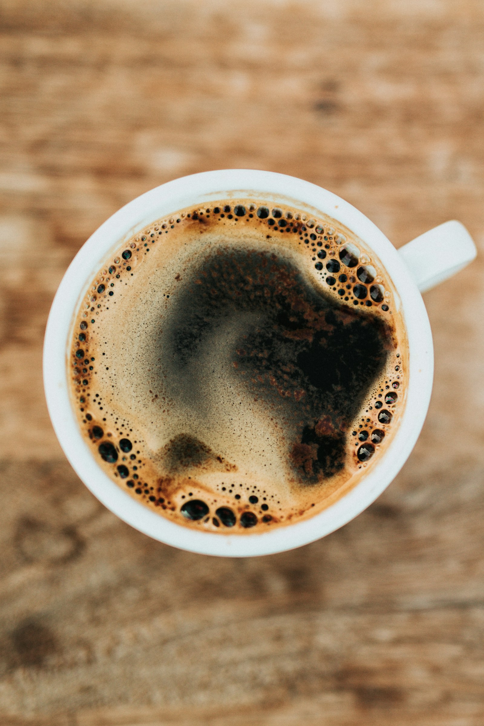 Pour-over coffee brewing with warm cafe light